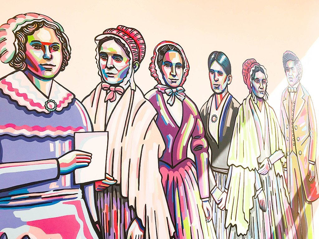An image of a colorful mural featuring influential leaders of the women's suffrage movement. An image of a colorful mural featuring influential leaders of the women's suffrage movement.