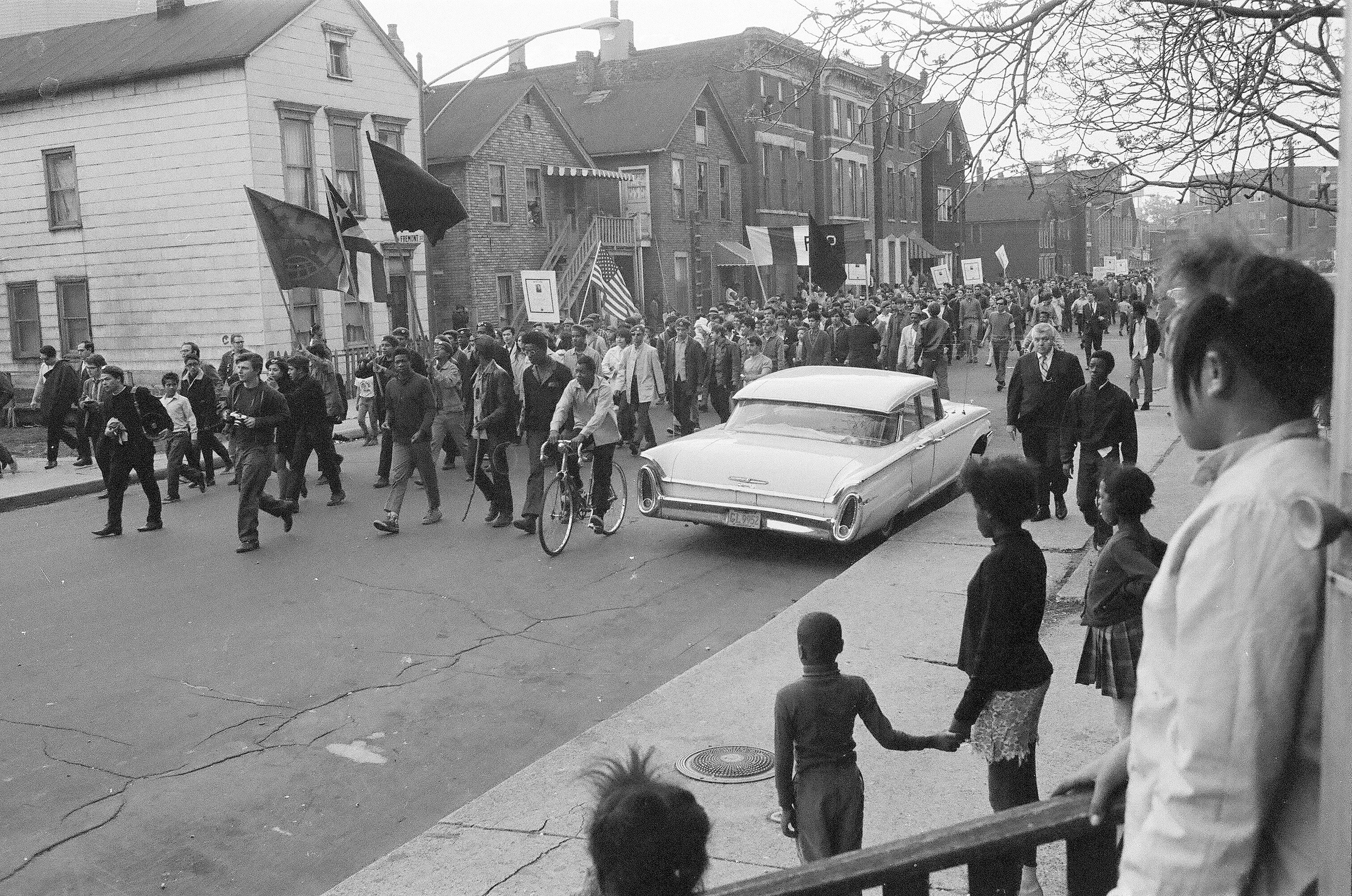 A black and white photo of multiracial protesters.