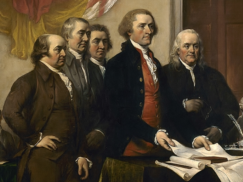A painting showing five prominent colonists standing as they present their draft of the Declaration of Independence, set out on a table before them.