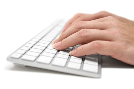 Woman's hands typing on keyboard