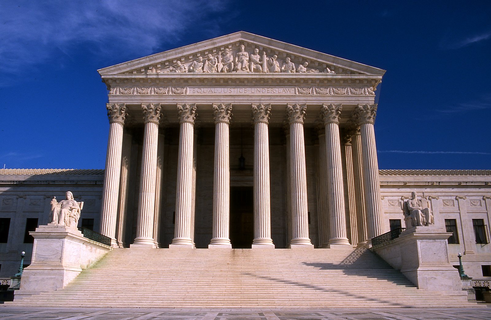 A photo showing the main entrance to the Supreme Court building. Steps lead up to a covered entryway held up by several columns.